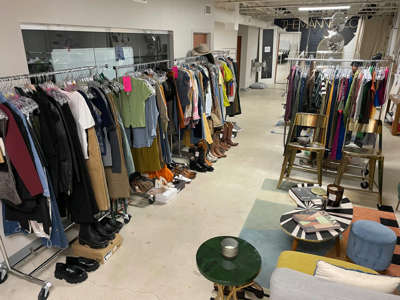 A studio lined with wardrobe racks, footwear, and styling references